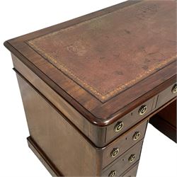 Victorian mahogany twin pedestal desk, moulded rectangular top with rounded corners and inset leather writing surface, fitted with nine drawers, on moulded plinth base