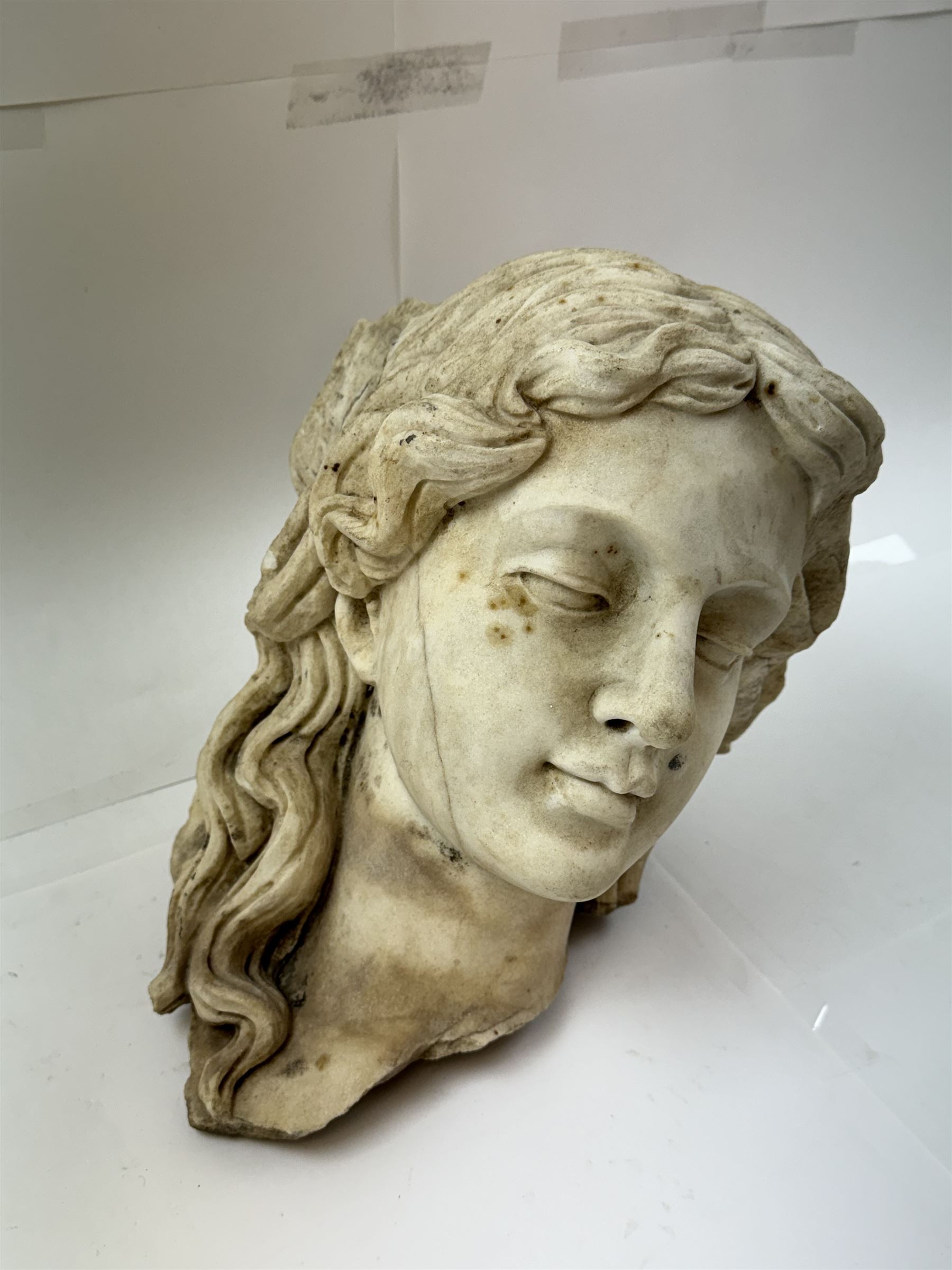 Fragmentary white marble head of a female bust, H31cm