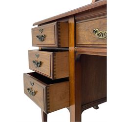 Late 19th century walnut dressing table, wide rectangular bevelled swing mirror in moulded frame, shaped horns carved with scrolls, moulded rectangular top over seven drawers, on square tapering supports with spade feet 