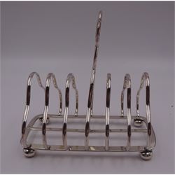 Victorian silver seven bar toast rack, each bar of trilobed form, with similar loop handle and upon four bun feet, hallmarked John Gilbert, Birmingham 1863, H16.5cm