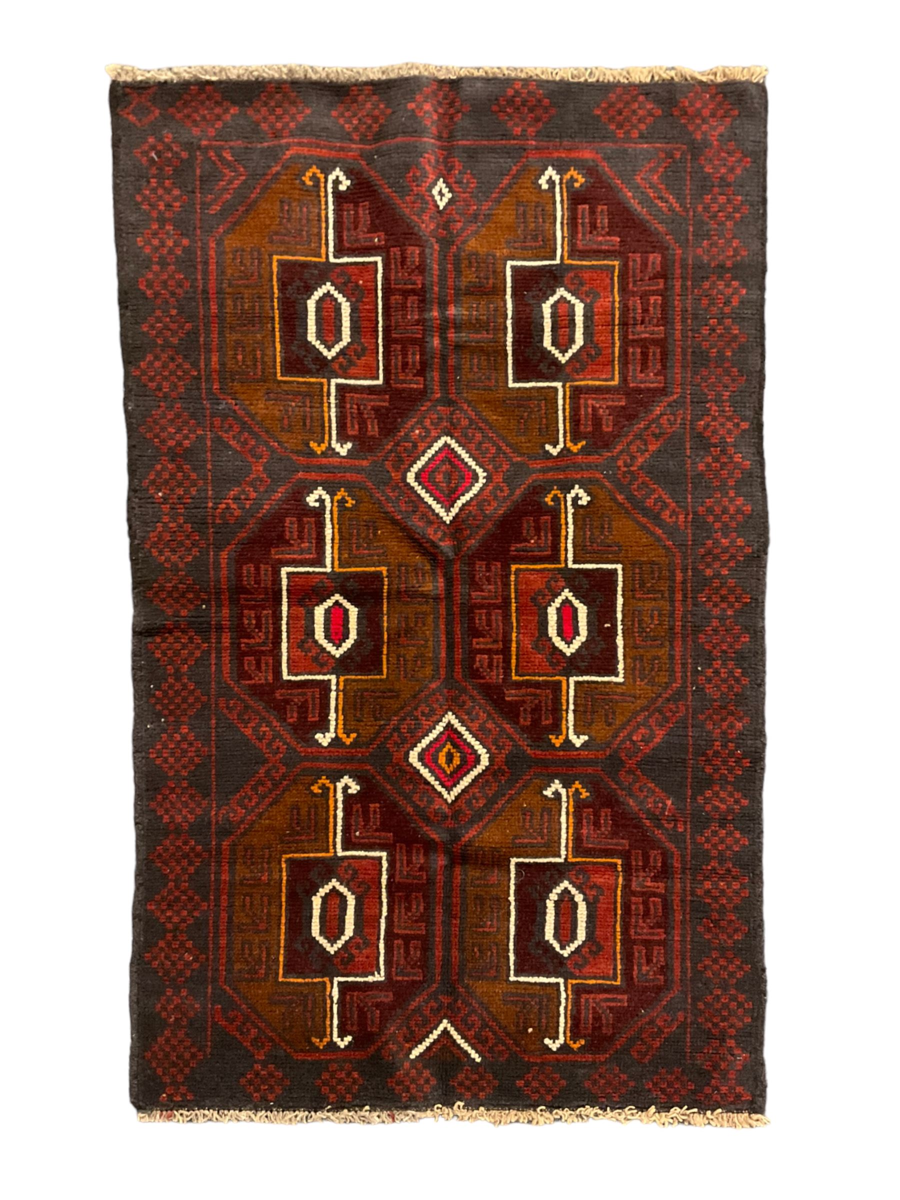 Baluchi red and blue ground rug, the field decorated with large six Gul motifs