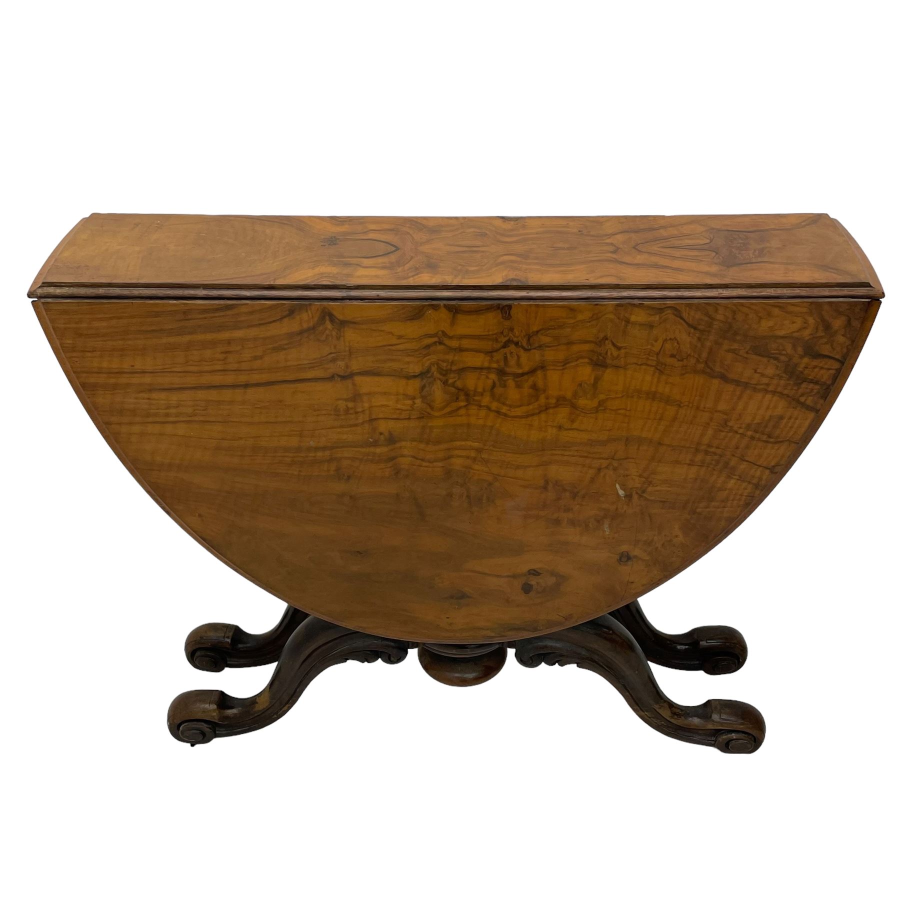 Unusual Victorian figured walnut drop-leaf Sutherland table, moulded drop-leaf oval top, central turned baluster column with quadruple moulded S-scroll supports carved with acanthus leaves, four out-splayed supports with scroll carved terminals, double gate-leg action base, on castors