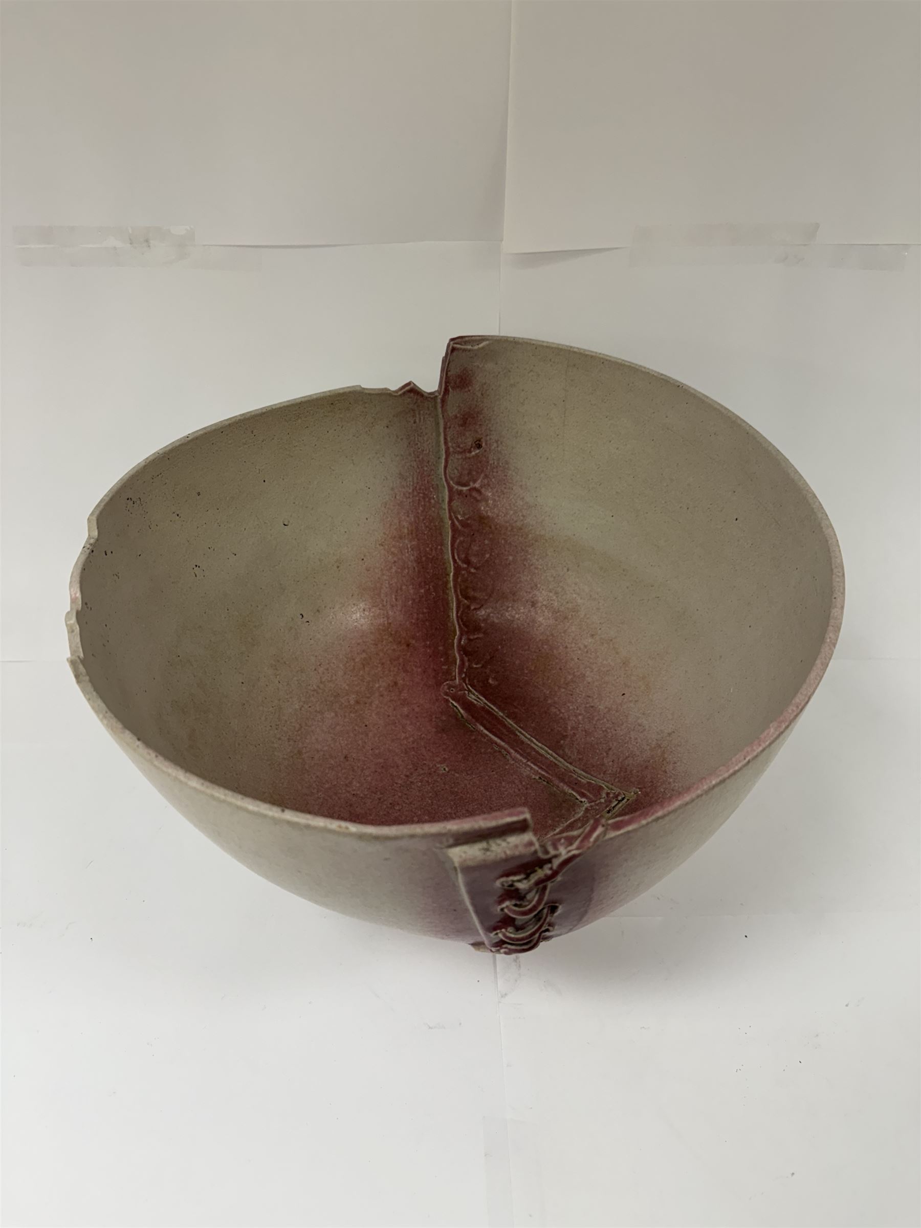 David Roberts (British 1947-): Studio pottery bowl 'Lace & Landscape', a footed bowl with laced sides and a shaped landscape rim upon a circular foot, finished in a pale pink glaze with darker pink highlights, H23cm, D32cm