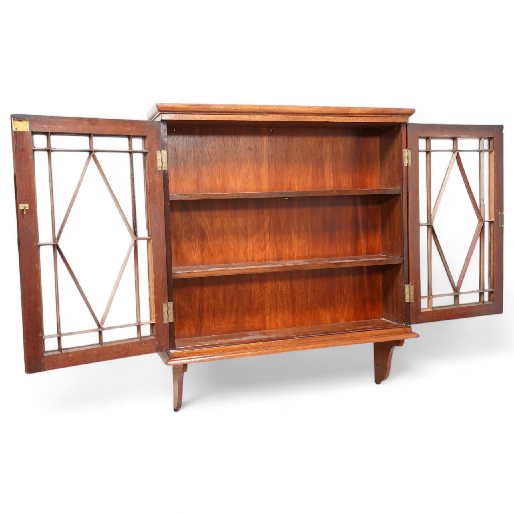 Edwardian inlaid mahogany wall-hanging cabinet, fitted with two astragal glazed doors enclosing two shelves, over shaped brackets