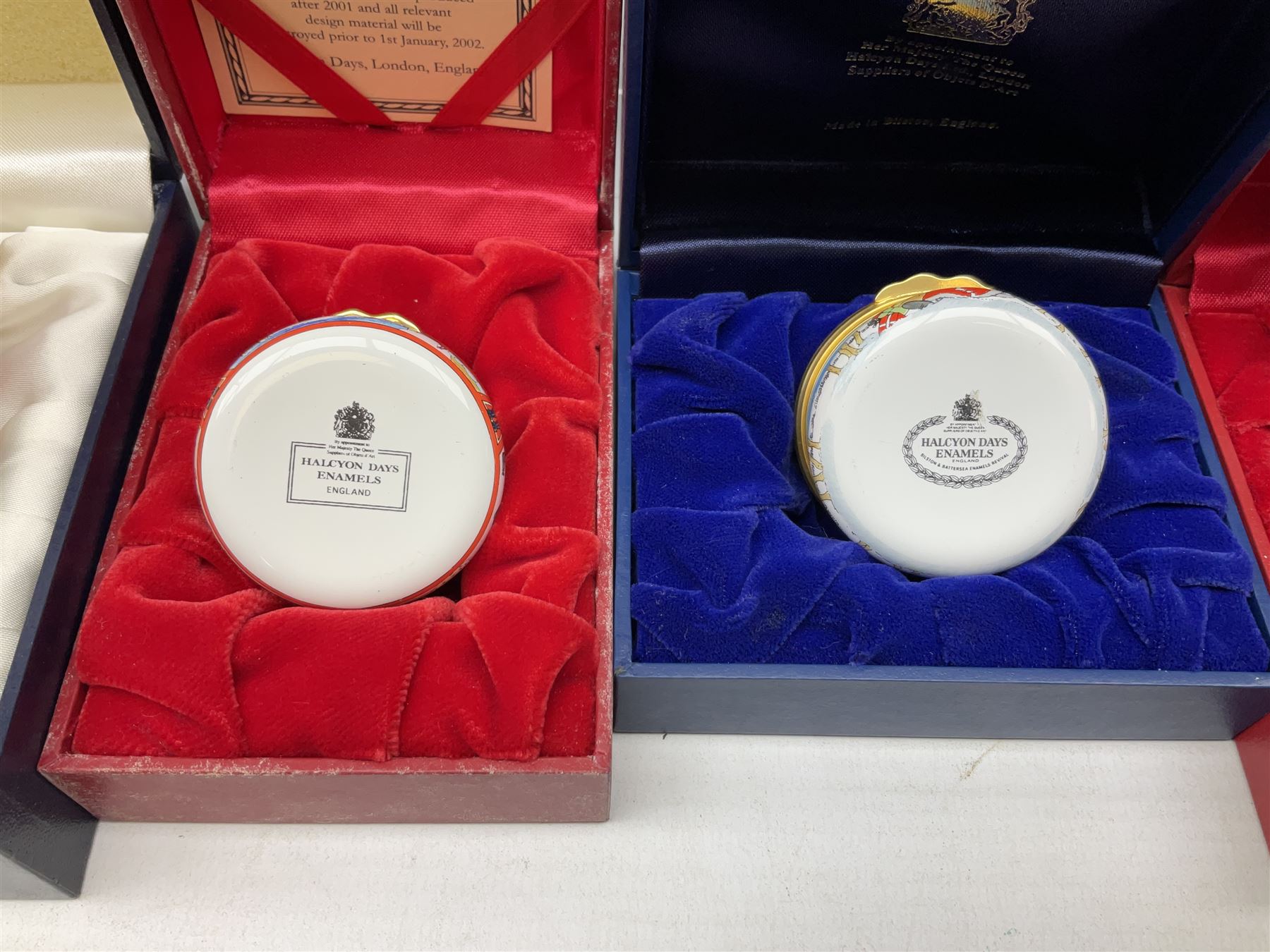 Eight Christmas themed Halcyon Days enamel boxes, and a Halcyon Days enamel bonbonniere modelled as a snowman, each in fitted box 