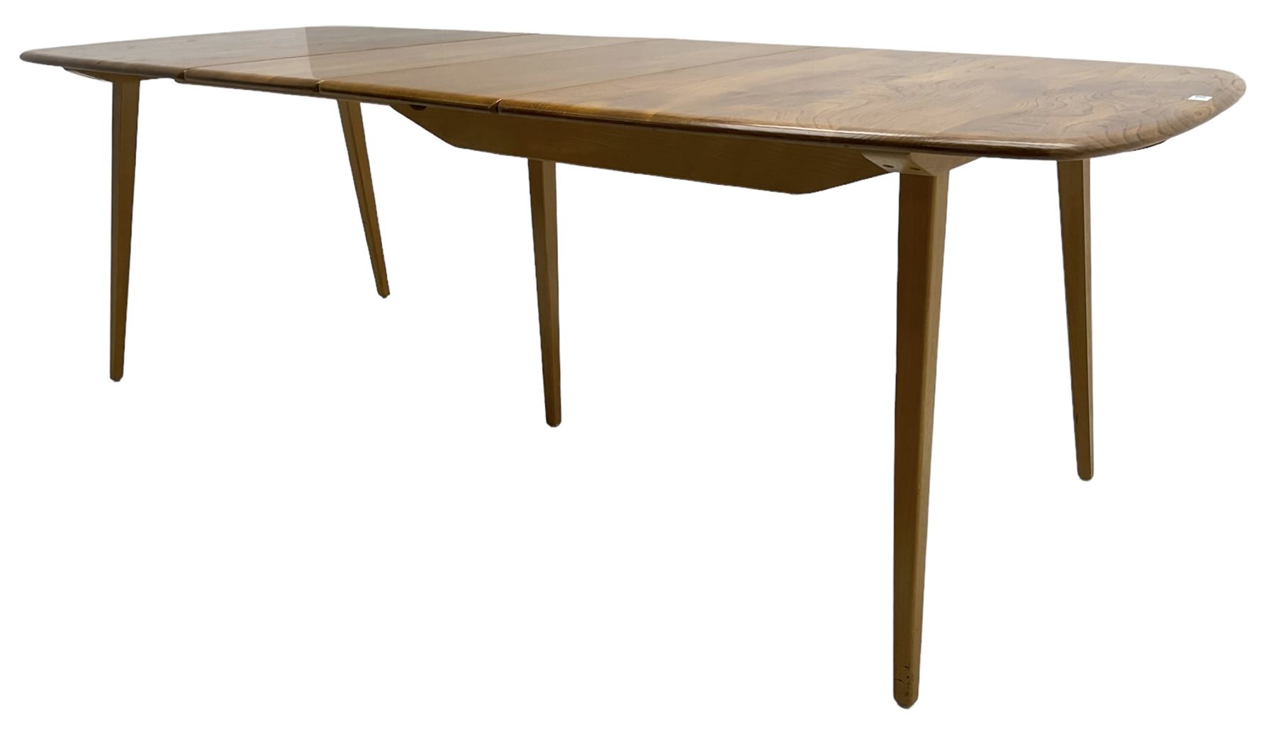 Ercol - light elm and beech 'Slide Leg Expanding Dining Table (444)', rectangular top with rounded corners, raised on tapered splayed supports, with two additional leaves