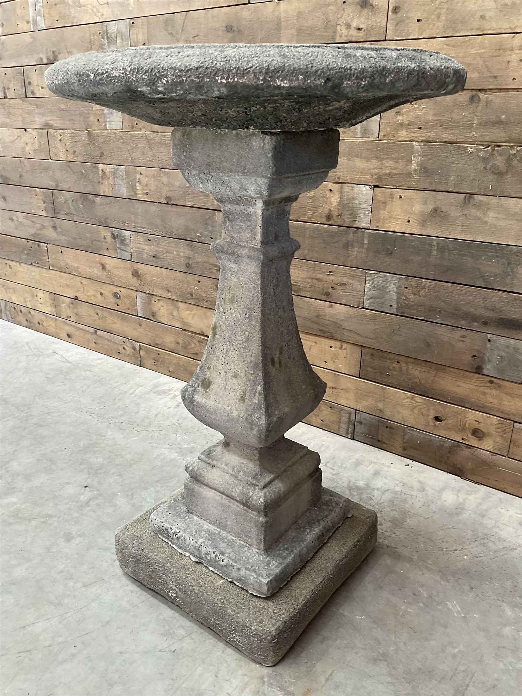 Cast stone garden bird bath, circular dished top, raised on square tapering column, on stepped base with separate mounting plinth