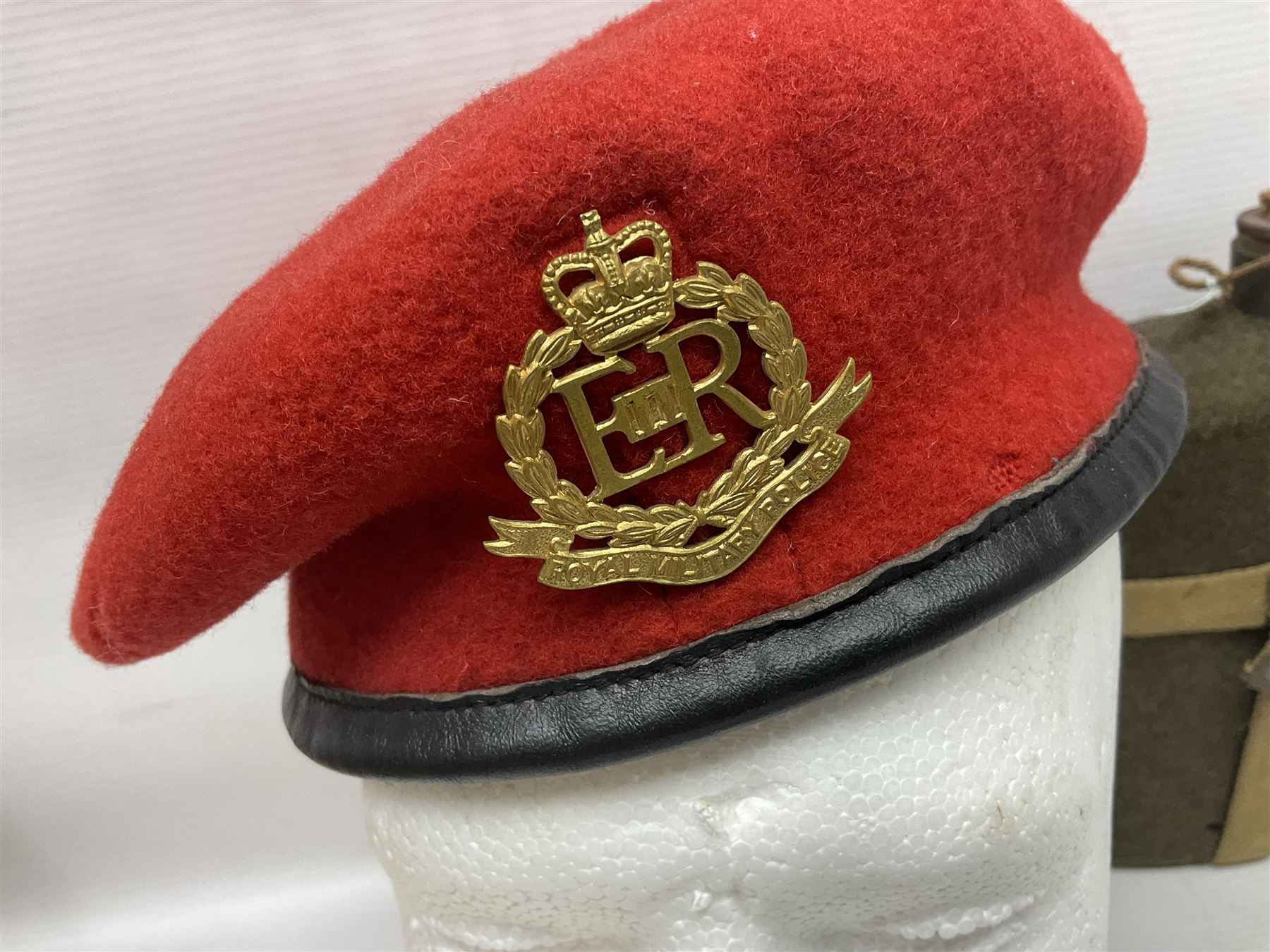 Five military caps/berets comprising two peaked caps with 'Yorkshire' and 'Royal Engineers' badges; maroon beret with parachute regiment badge; red beret with Military Police badge; and AB seaman hat with HM Submarines band; and a felt and webbing covered water bottle (6)