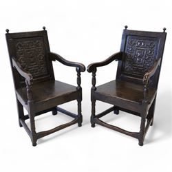 Pair 17th century design wainscot open armchairs, the cresting rail with turned finals over panelled back, the panel carved with geometric pattern and flower heads, shaped arms over plank seat, on turned supports united by stretchers 