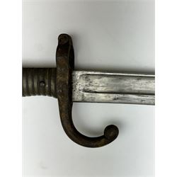 WWI French Chassepot Sword bayonet 57cm steel blade inscribed to the back-edge 'Tulle Juillet 1874', the cross-guard with indistinctly impressed number, in its steel scabbard, L71cm