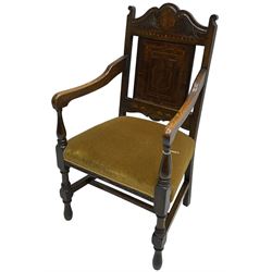 Late 19th to early 20th century oak elbow chair, the shaped cresting rail carved with scrolls and foliage, panelled back inlaid with parquetry work and central rampant lion within shield, upholstered seat, on turned supports joined by H stretchers