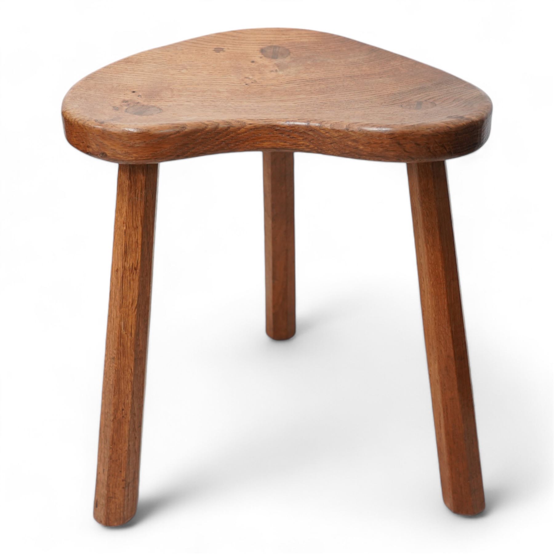 Mouseman - oak kidney-shaped stool, on three tapered octagonal supports, carved with moues signature, by the workshop of Robert Thompson, Kilburn 