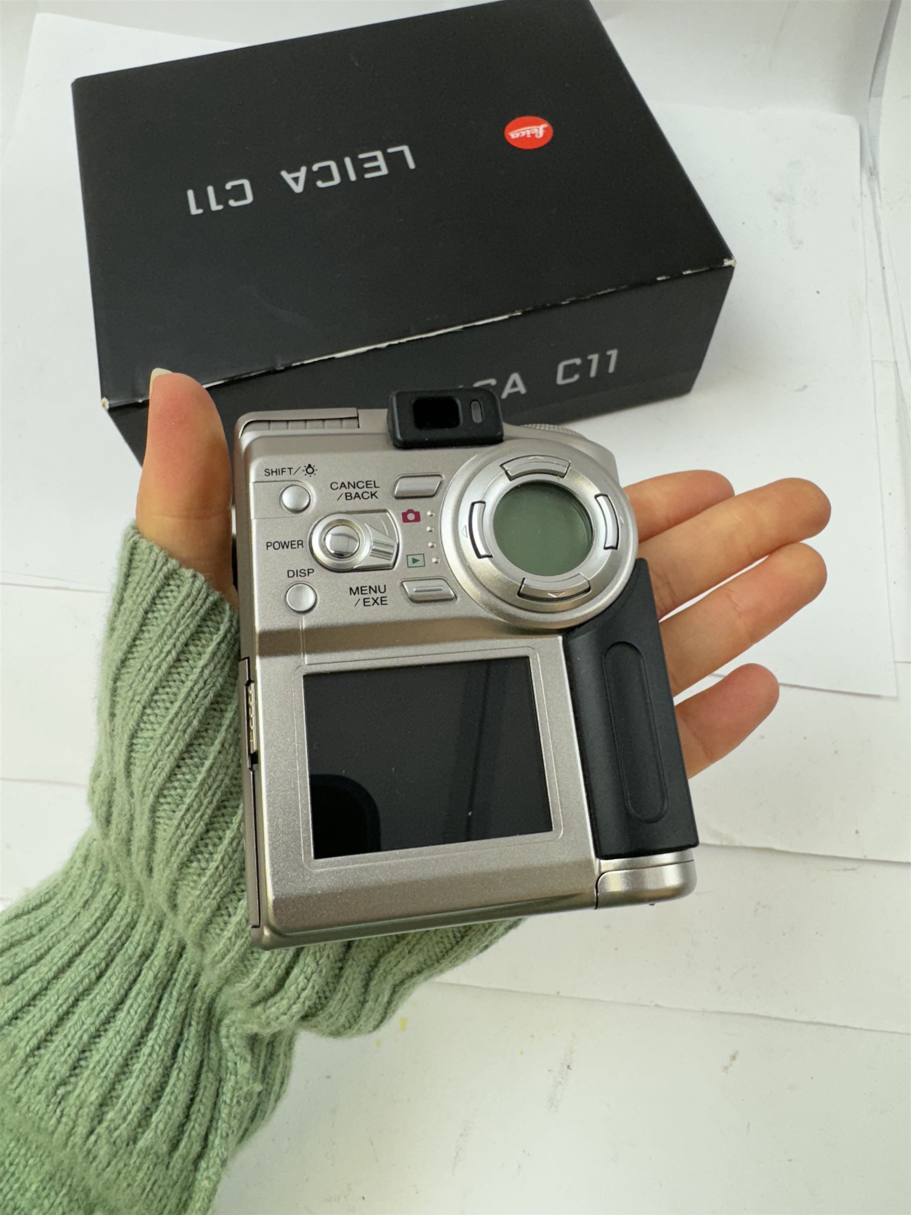 Leica C11 APS film compact camera, in silver and chrome finish, serial no. 2636834, in original clear hard case and box, with instruction booklet, together with a Leica Digilux 4.3, with 1:2.8-4.5/8.3-24.9mm lens, serial no. 2598862, with instruction booklet