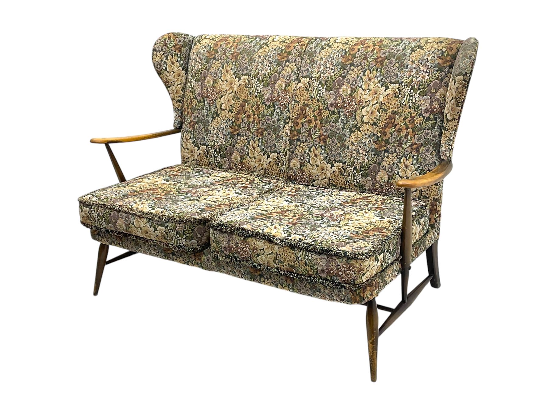 Lucian Ercolani for Ercol - mid-20th century beech and elm 'Windsor 203' two-seat sofa, wingback design upholstered in floral pattern over sprung seat and backrest, open curved arms, on splayed supports with stretchers (W133cm, D87cm, H90cm); matching easy chair (W70cm, D97cm, H82cm)