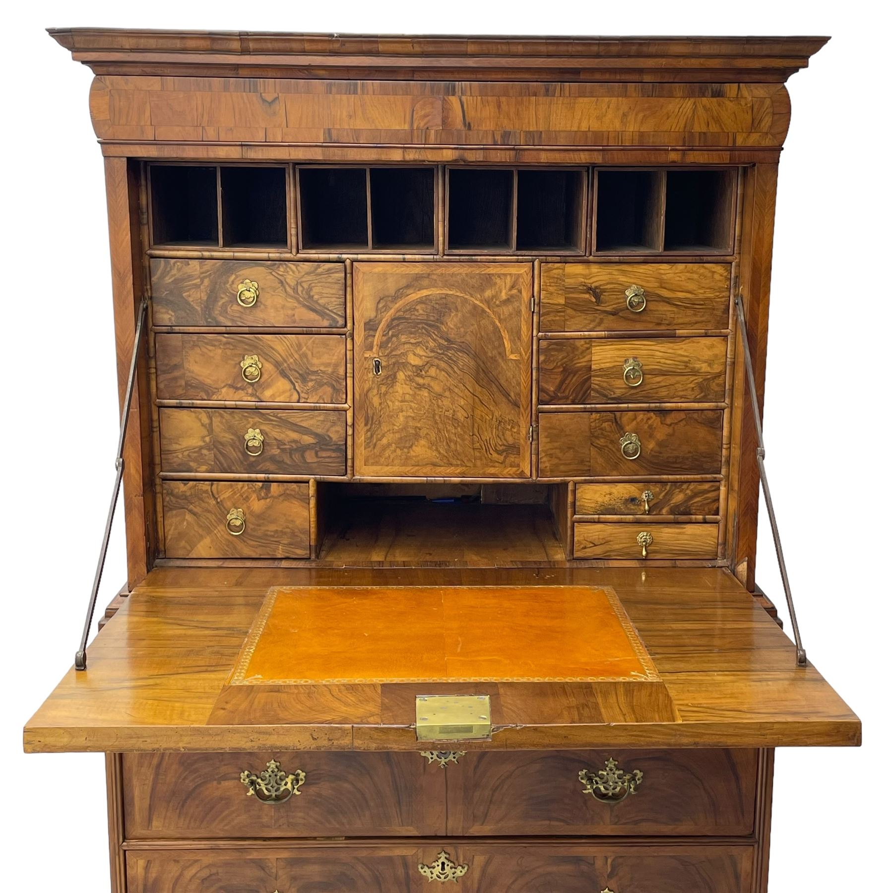 Early 18th century William & Mary figured walnut escritoire, projecting moulded cornice over shallow frieze drawer, the figured fall front enclosing interior fitted with small drawers, cupboards, pigeon holes and hidden drawers, the lower section fitted with two short and two long graduating drawers, on tall bracket feet 