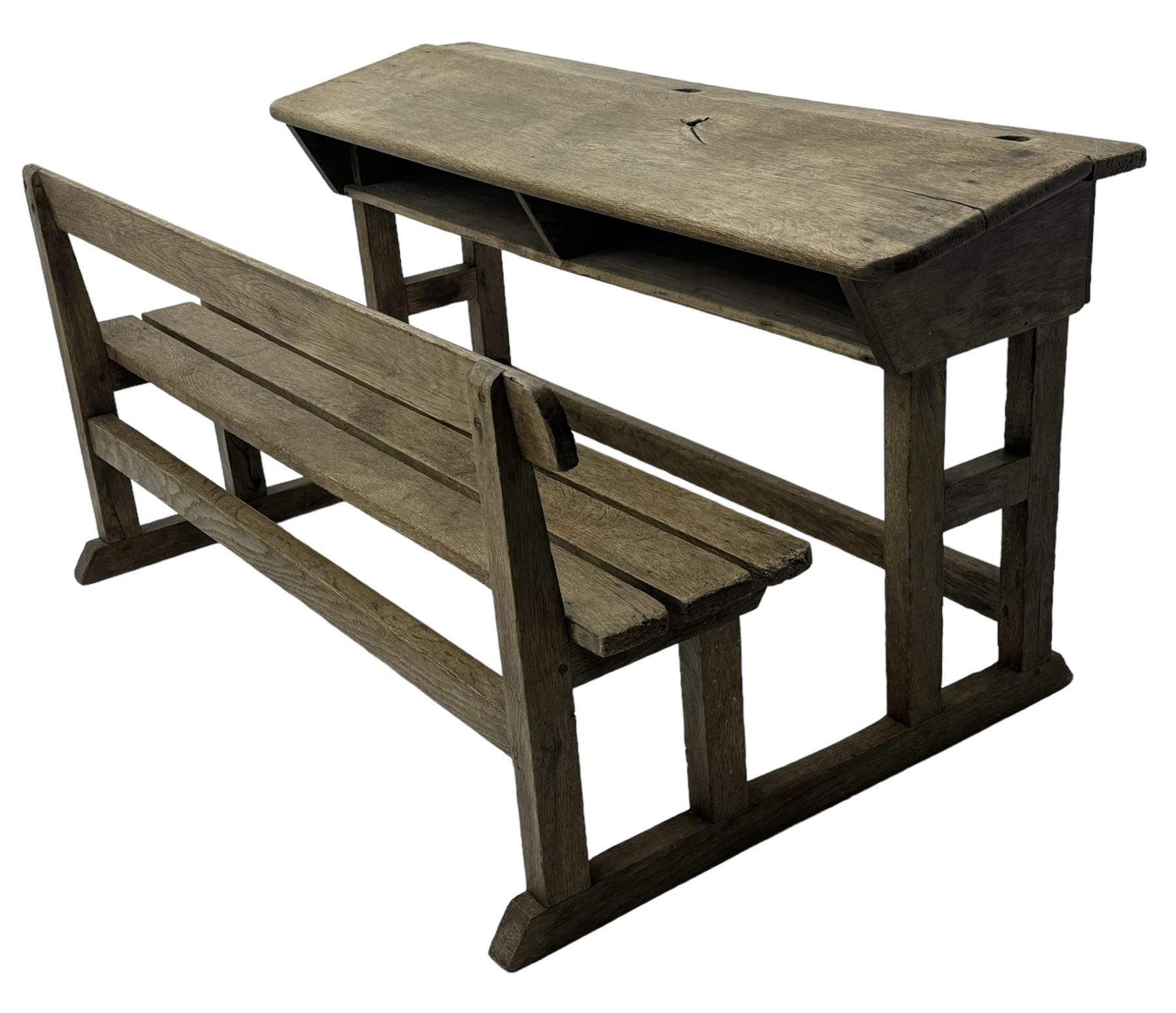 Victorian child's pine double school desk, the writing surface with two inkwells and two shelves underneath, integrated slatted bench seat raised on supports united by stretcher 