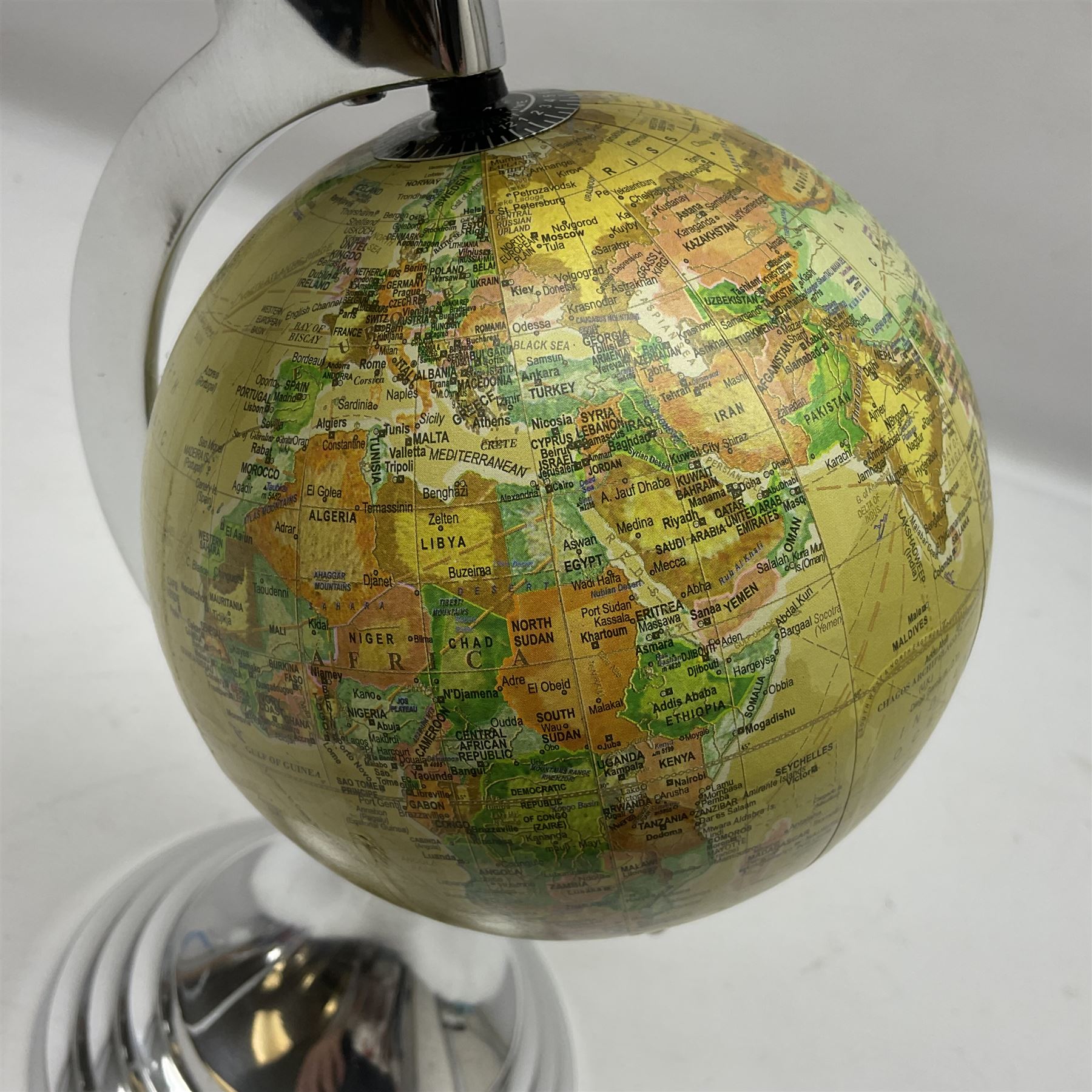 Art Deco style world globe with chrome aeroplane finial and mounts, H31cm