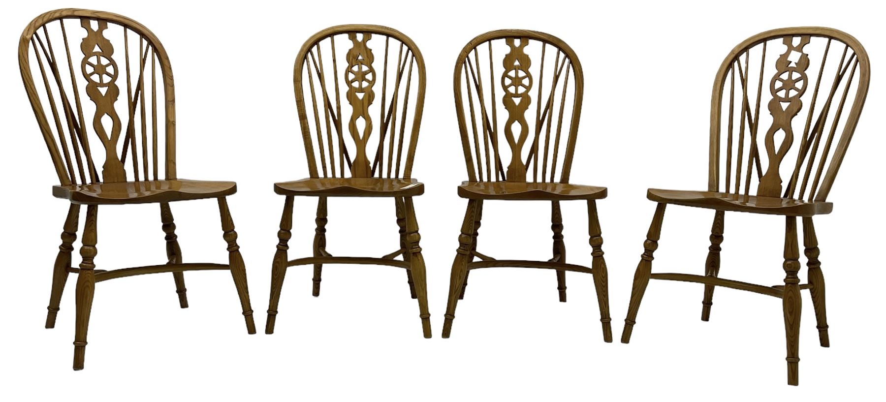 Set of four elm Windsor dining chairs, hoop and stick back with shaped wheel splat, dished seat on turned supports united by crinoline stretcher 