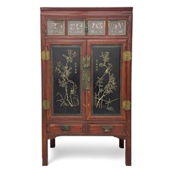 Late 19th century Chinese Qing dynasty red and black lacquered wood cabinet, Fujianese province, upper cupboard enclosed by two doors with relief carved and gilt panels depicting figures behind glass, the large cupboard enclosed by two panelled doors carved with trailing foliate branches and birds, inscribed with Chinese characters, to the left ‘Prolong life’ and to the right ‘Wealth and good fortune’, fitted with two drawers, square supports with carved brackets 