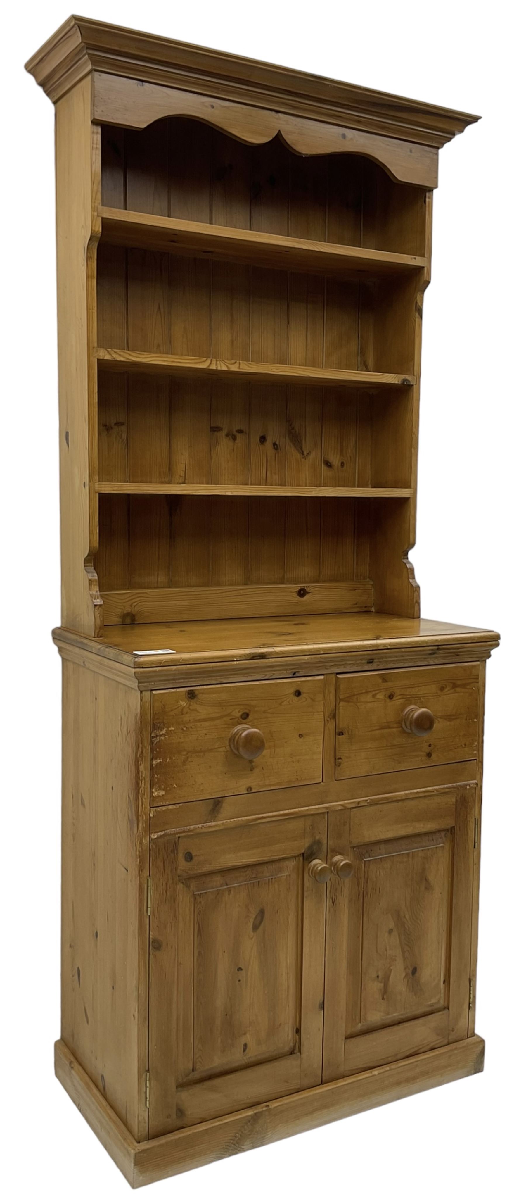 Solid pine dresser, fitted with plate rack above two drawers and two cupboards