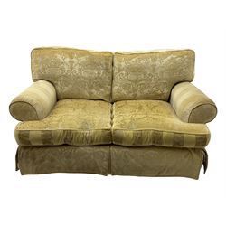 Contemporary two-seat sofa, upholstered in damask fabric with a pale gold floral pattern, rolled arms, loose back and seat cushions, on matching skirted base with concealed castors