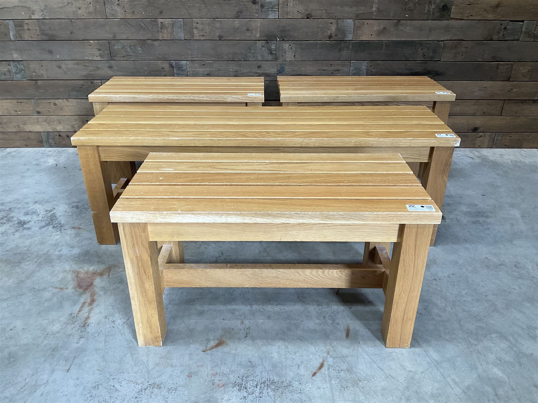 Three small light oak benches and a large bench