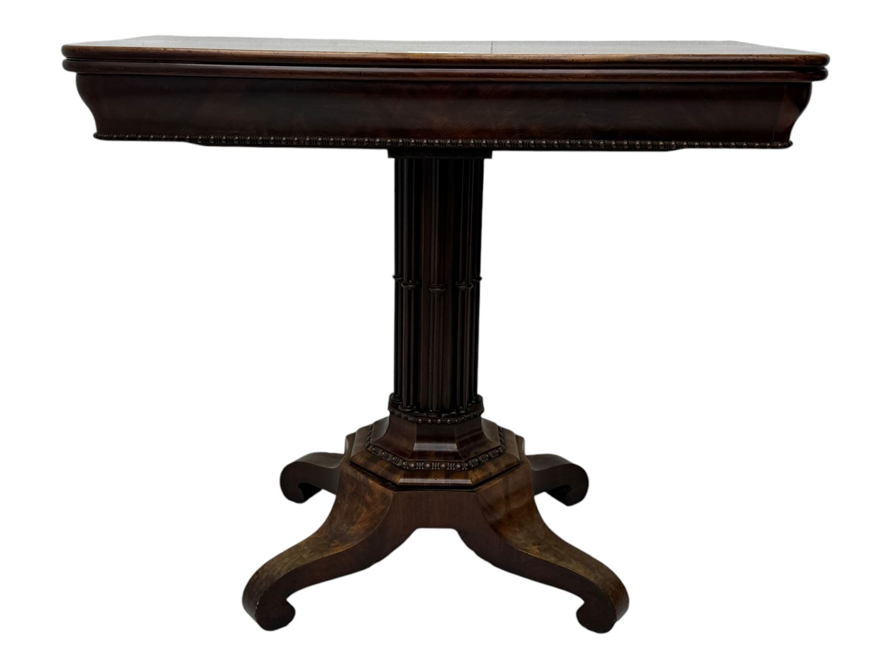 Victorian mahogany tea table, rectangular fold-over and swivel action top with rounded corners, ogee moulded frieze with applied bead, octagonal column mounted by cluster column uprights, on step moulded octagonal foot with applied beading, splayed and scrolled feet with recessed castors 