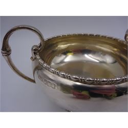 Early 20th century silver twin handled bowl, of plain bellied form with bead and dart rim and two C scroll handles, upon a circular foot, hallmarked Walker & Hall, Sheffield 1919, including handles H9.5cm