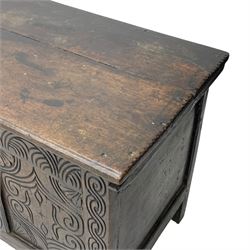 18th century oak blanket box, moulded and chip carved hinged lid, lunette carved cresting rail over triple panelled front carved with stylised leaf and scroll decoration, interlocking S-scroll carved upright rails, panelled sides and back, on stile supports 