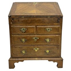 18th century walnut bureau, fall-front enclosing fitted interior with drawers and pigeonholes, over two short and two long drawers with brass escutcheon plates and handles, raised on bracket feet