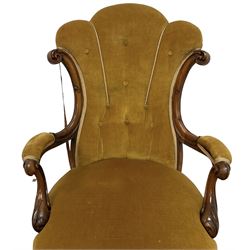 19th century walnut framed open armchair, scallop shaped back with c-scroll uprights, upholstered in yellow buttoned velvet fabric with sprung seat, arm terminals carved with acanthus leaves, raised on scrolling cabriole supports with castors