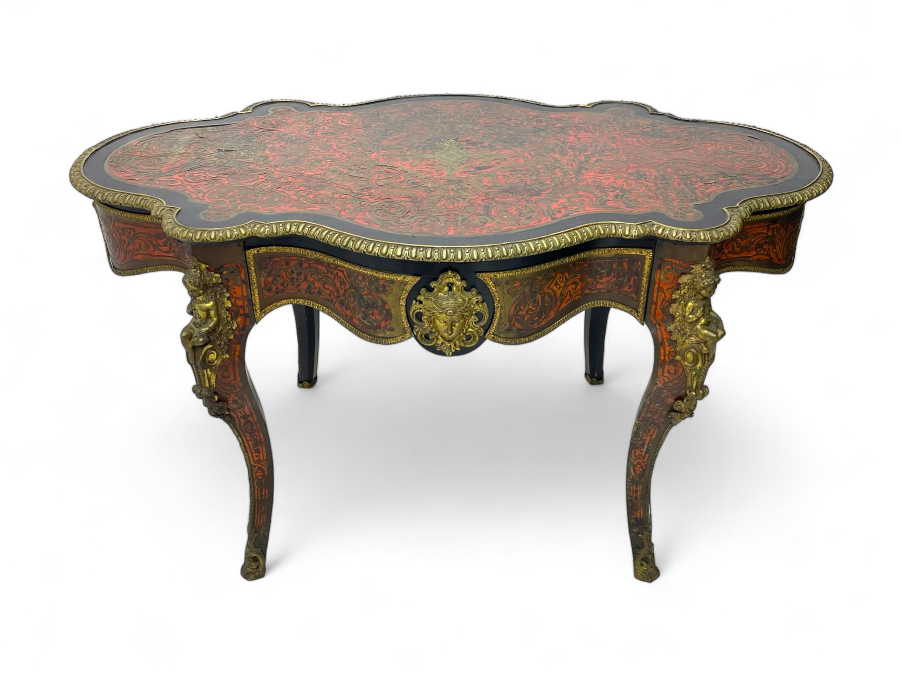 Victorian Louis XV design boulle work centre table, shaped form, decorated extensively with brass and red tortoise shell scroll work, central extending acanthus leaves surrounded by scrolling foliage, gardroon and floral cast brass edge, the frieze rails decorated with further boulle work and green man gilt metal cast masks, the cabriole supports mounted by seated putti mounts on S-scroll brackets surrounded by oak leaves and acorns, ornate scroll and floral cast terminal caps