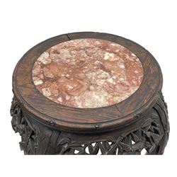 Early 20th century Chinese hardwood plant stand, circular top with marble inset, carved and pierced with interlacing foliage, on leaf carved supports united by x-framed stretchers