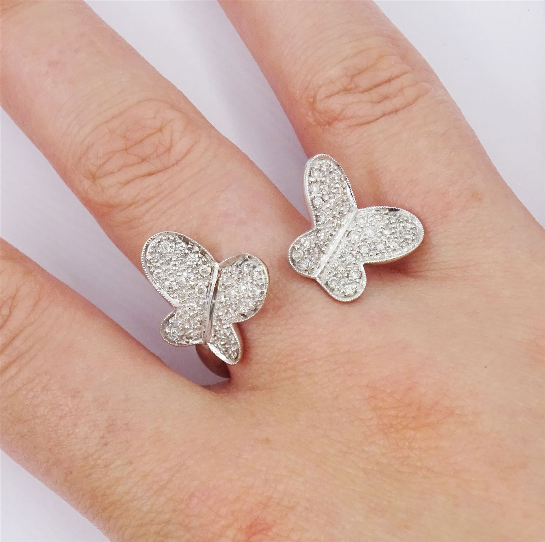 18ct white gold pave set diamond butterfly suite including ring, pair of stud earrings and pendant / brooch, all stamped 750