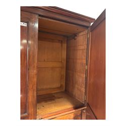 Victorian mahogany linen-press, moulded cornice over two figured panelled doors, the interior fitted with five slides and hanging rail, four long drawers below 