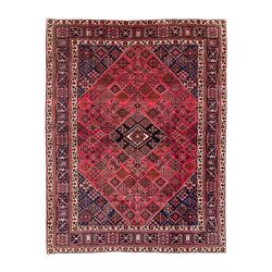 Persian Joshaghan red ground rug, the medallion, field and spandrels decorated with Pitrak and tree of life motifs, the border with repeating design decorated with stylised plant motifs, within guard stripes