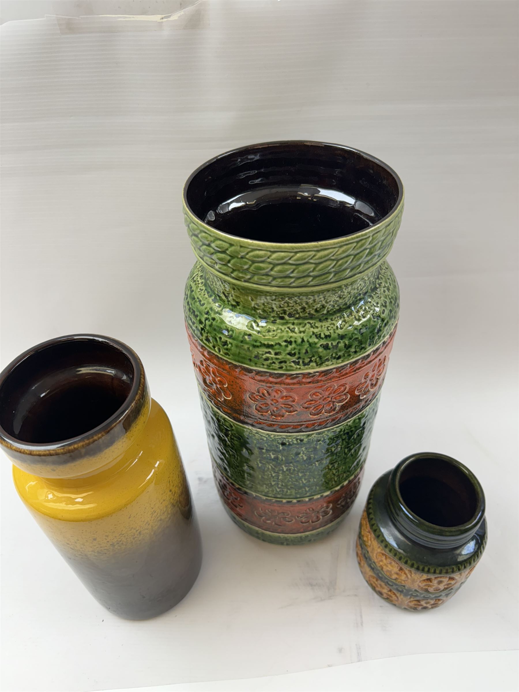 Three West German vases, to include orange and green example with floral decoration and a similar smaller example, tallest H40cm