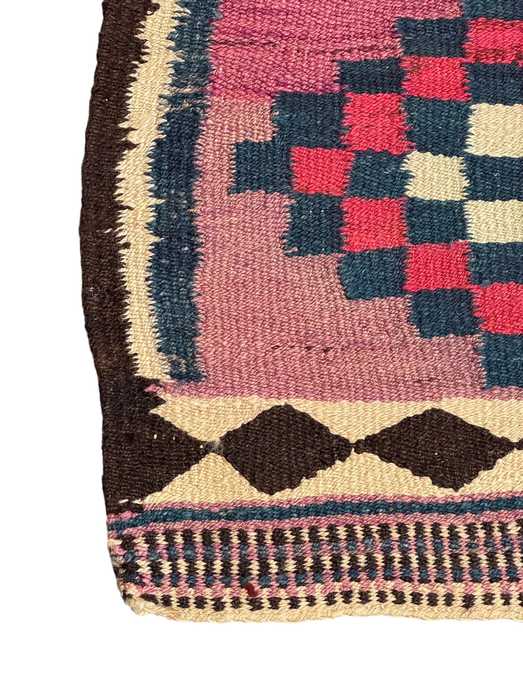 Turkish Anatolian lilac ground kilim rug, the field decorated with three columns of geometric lozenges, enclosed by plain guard stripes 