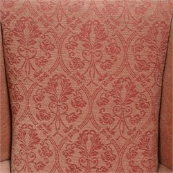 Hardwood-framed wingback armchair, upholstered in peach fabric, on cabriole feet 