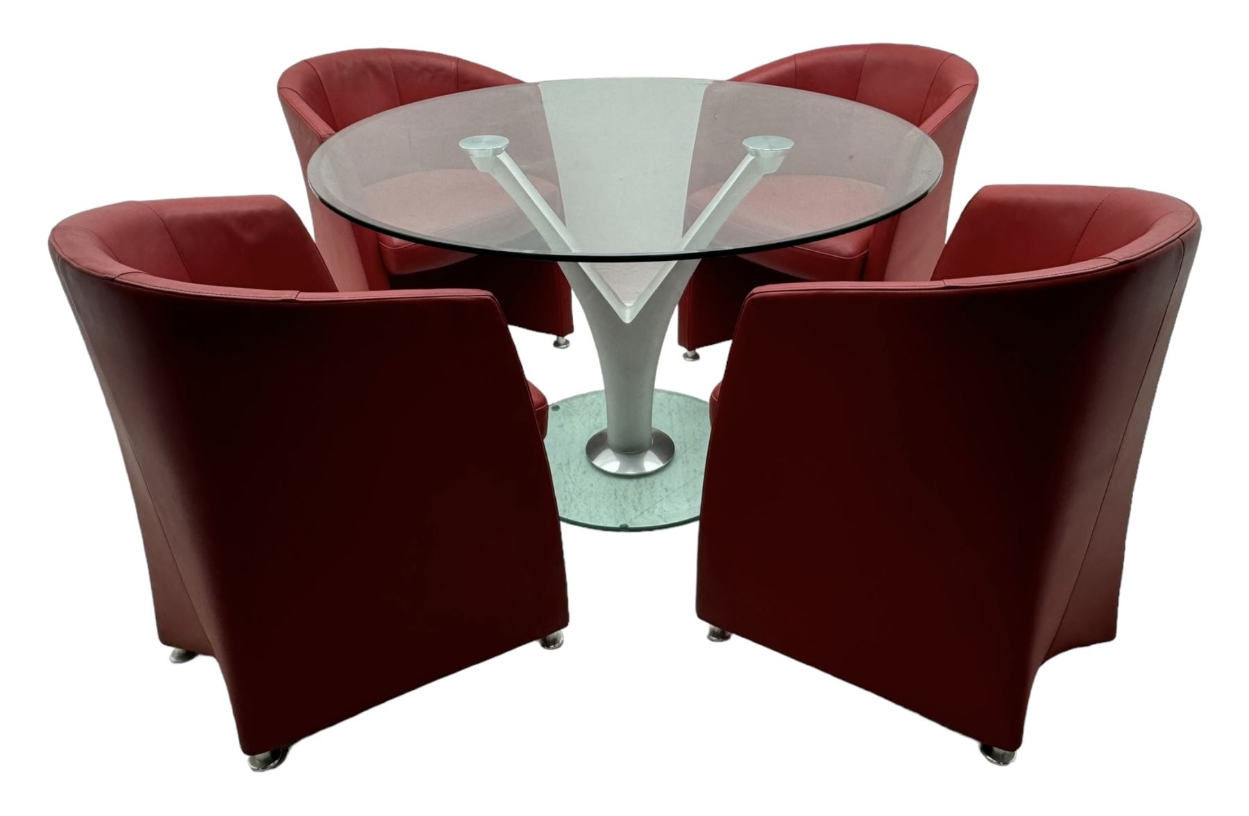 Rolf Benz glass dining table, circular bevelled glass top supported by central Y-shaped brushed metal column, terminating in circular glass base; four red leather tub chairs with curved backrests and vertical stitching, on round chrome feet (5)