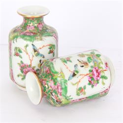 Pair of Chinese famille rose miniature vases, painted with panels depicting figures in a garden, with flora and fauna decoration, H10cm