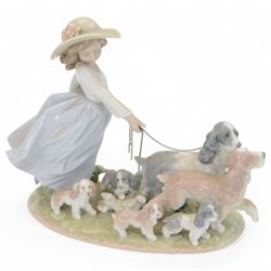 Lladro figure group Puppy Parade, modelled as a girl with seven dogs, no 6784, with original box 