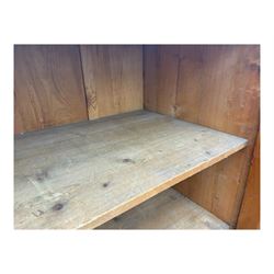 Large 19th century pine cupboard, rectangular top over two panelled later doors, enclosing four open shelves, on plinth base