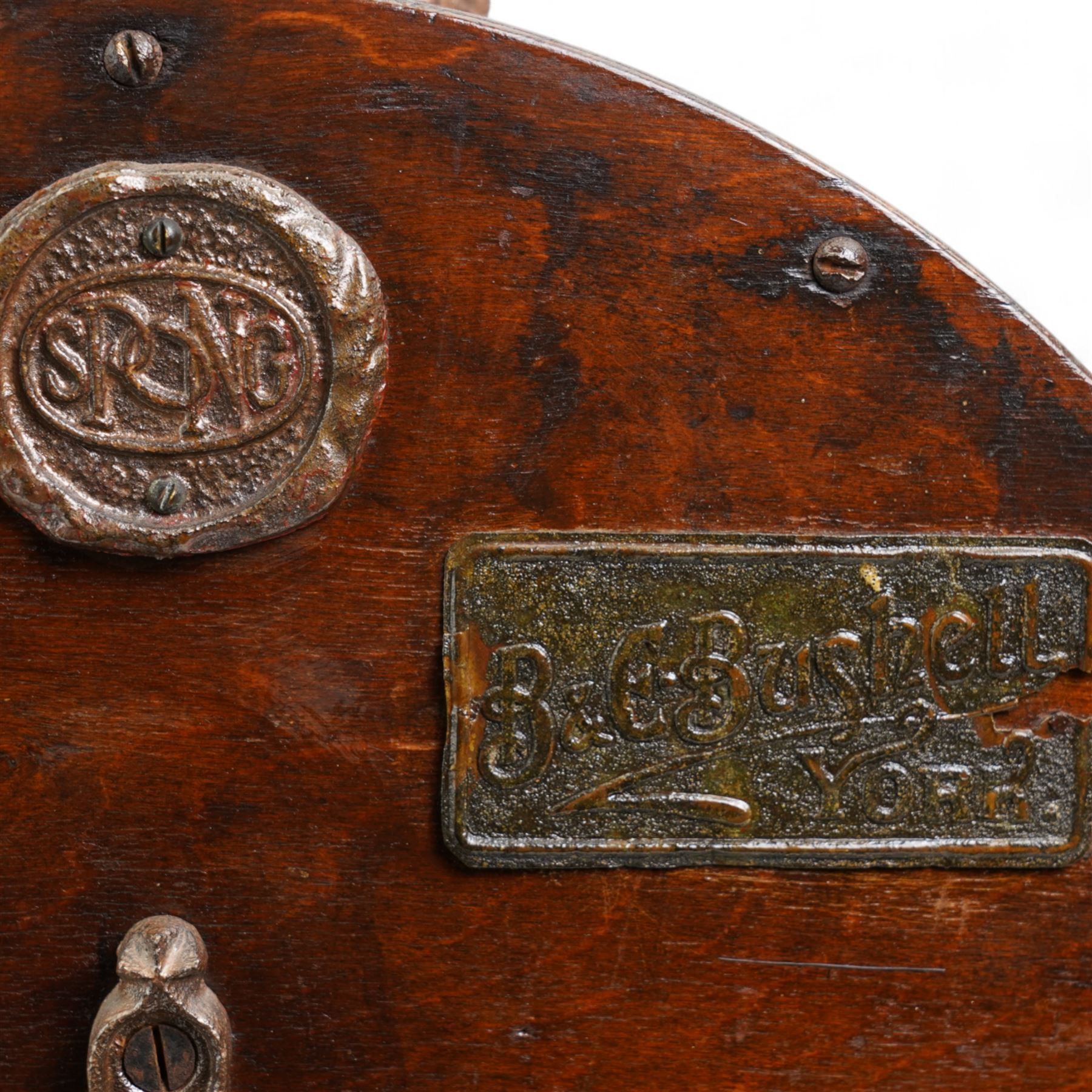 Edwardian knife polisher by Spong and retailed by B & E Bushell, York, on cast iron base and mounted on later wooden stand, H51cm x L67cm