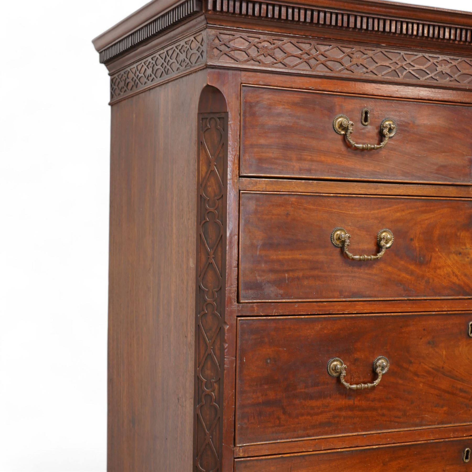 George III mahogany chest-on-chest, projecting dentil cornice over blind fretwork frieze, fitted with two short and six long cock-beaded drawers, ornately cast swan neck handles and circular beaded plates, on splayed ogee bracket feet 