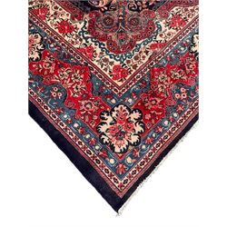 Persian Mahal indigo ground carpet, floral medallion on a field of swirling leafy branches and flower heads, shaped ivory field band decorated with flower head bouquets and trailing branches, the border decorated with floral motifs, within guard stripes