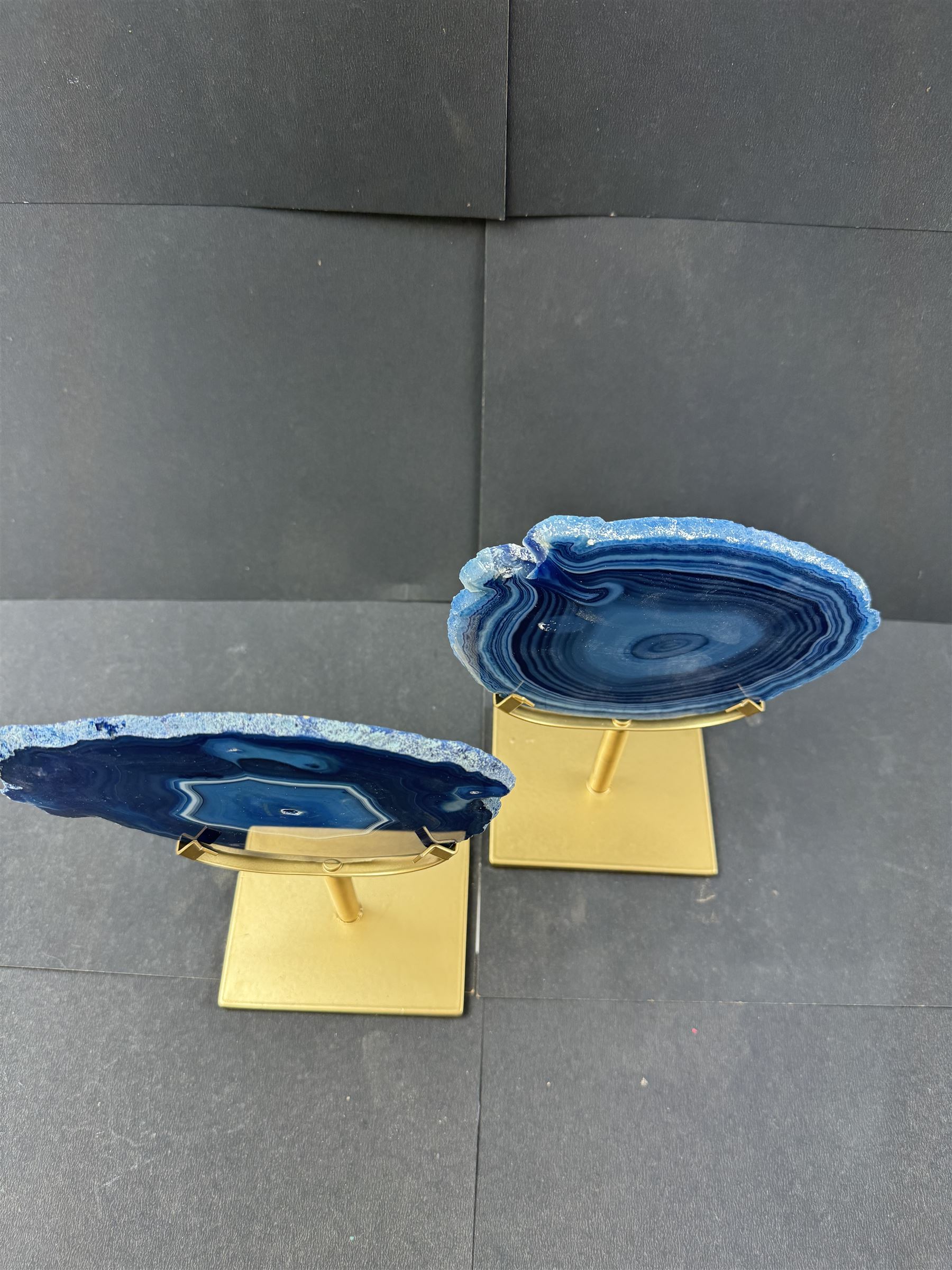 Pair of blue agate slices, polished with rough edges, raised upon gilt metal stands, H20cm