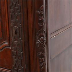 19th century French walnut hall cupboard, the frieze carved with a bouquet of flowers and trailing foliate decoration, enclosed by single panelled door over single drawer, the curved outer corners decorated with trailing leafy branches and flower heads, shaped apron with scroll carved cabriole feet 