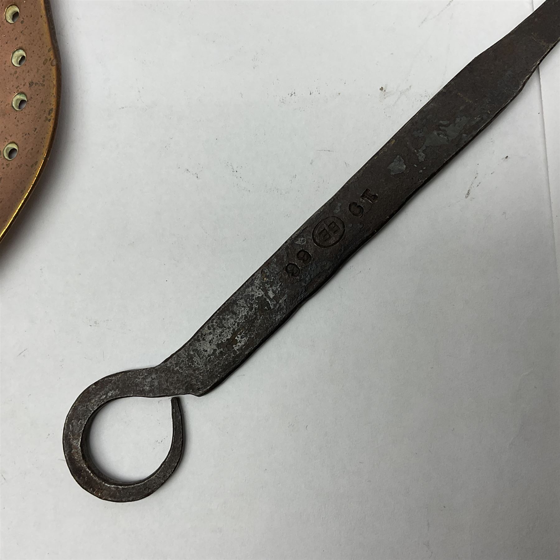 Large 19th century copper slotted spoon, with pierced flat bowl, L55cm, together with two 19th century iron handled ladles with circular copper bowls, largest example L48.5cm, (3)