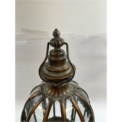 Pair of patinated brushed brass lanterns, of domed hexagonal form, with pierced gallery and swing handle, H63cm 


